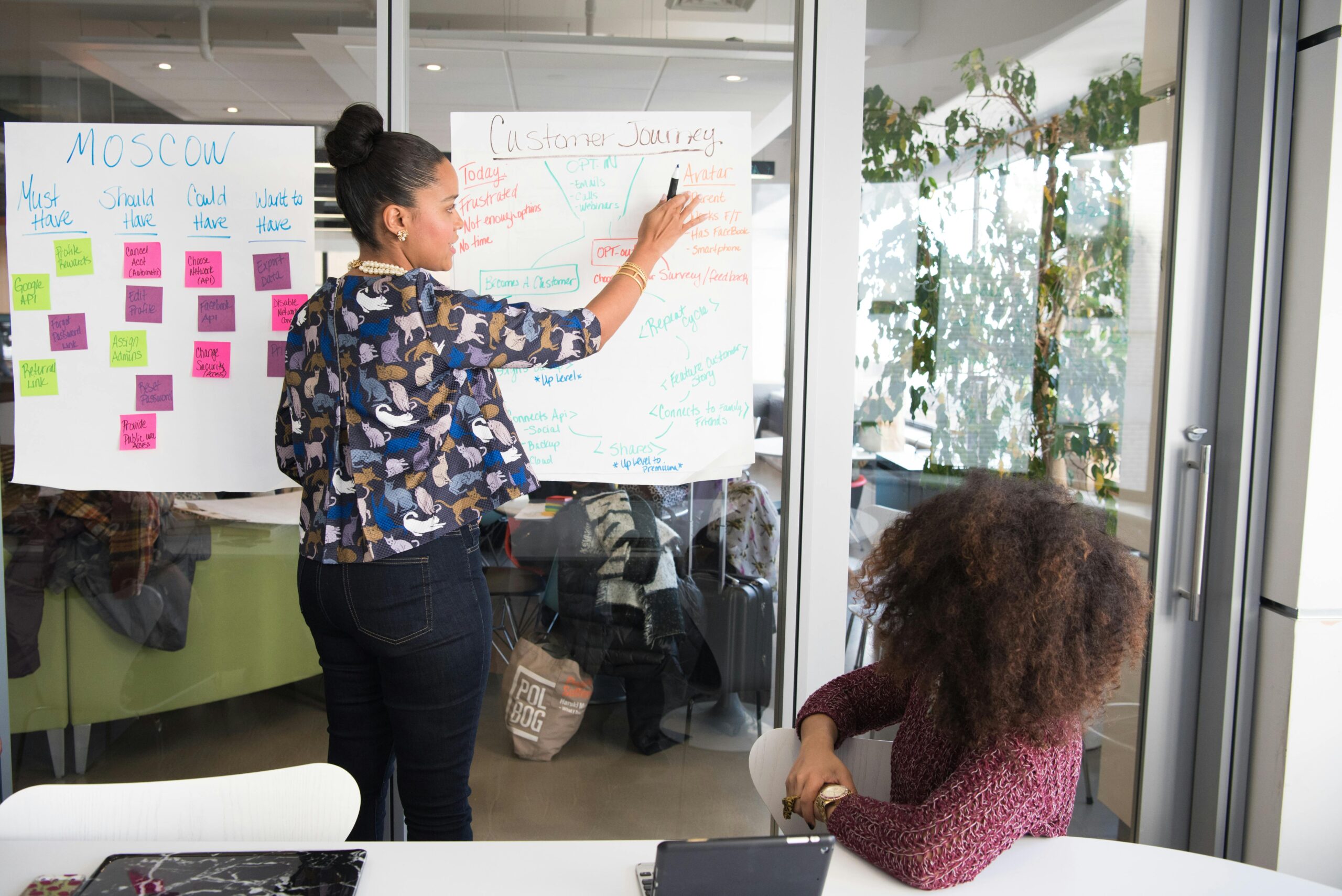 Woman teaching girl with flipchart.